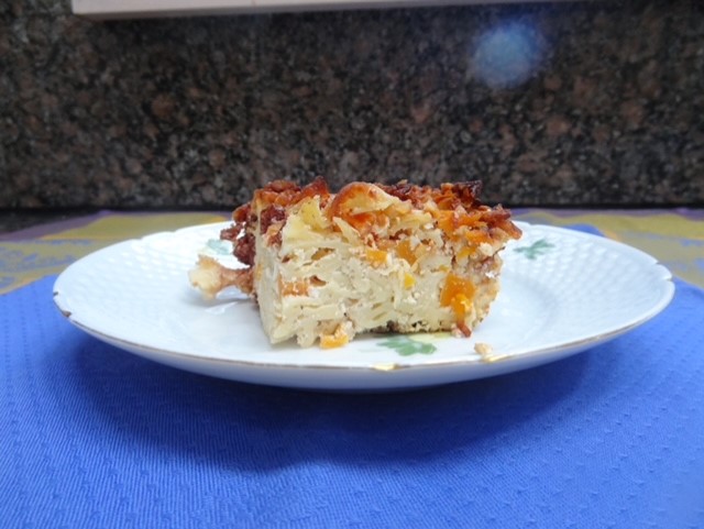 On a plate there is kugel made by Ronnie Fein.