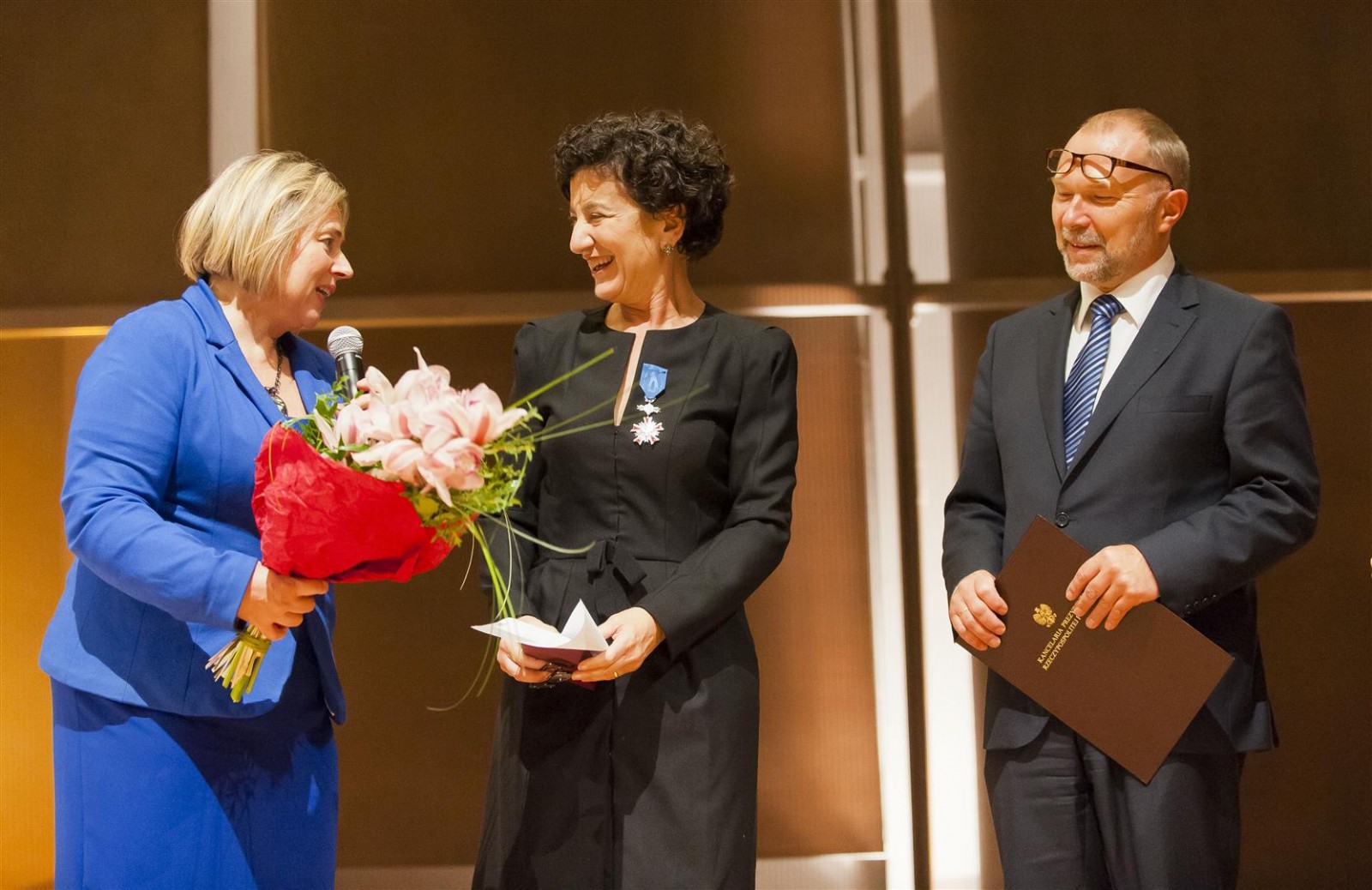Kobieta wręcza kwiaty laureatce nagrody Ireny Sendlerowej.