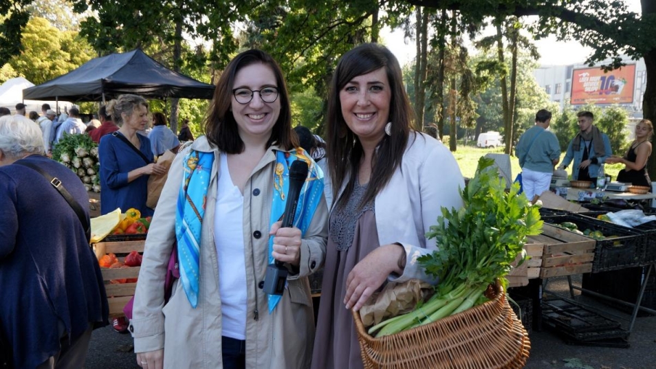 Marysia Ostrowska and Mary Seidler. They are in the market having some vegatables in the basket. They both smiling.