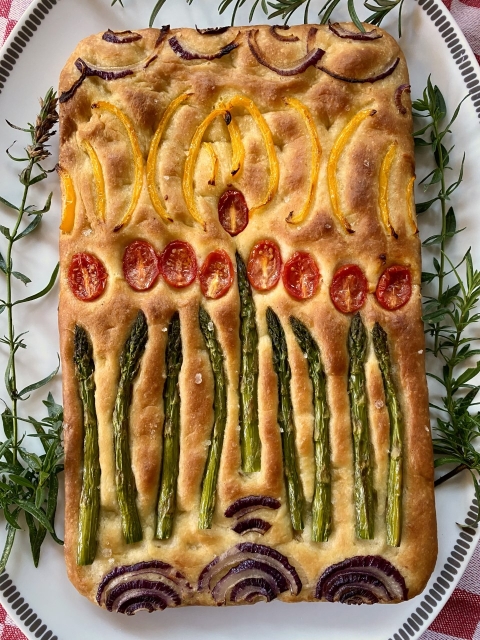 Chanukah foccacia by Helen Goldrein on a plate.