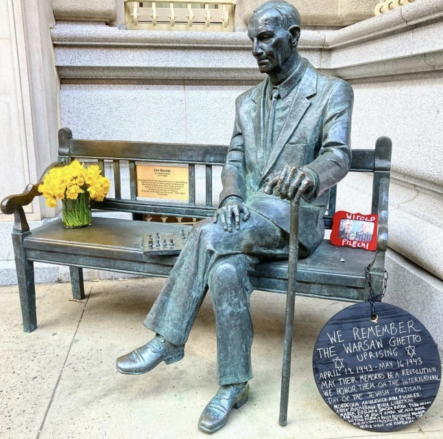 Jan Karski's bench next to Polish Institute in New York. There is bouqet of daffodils on it.