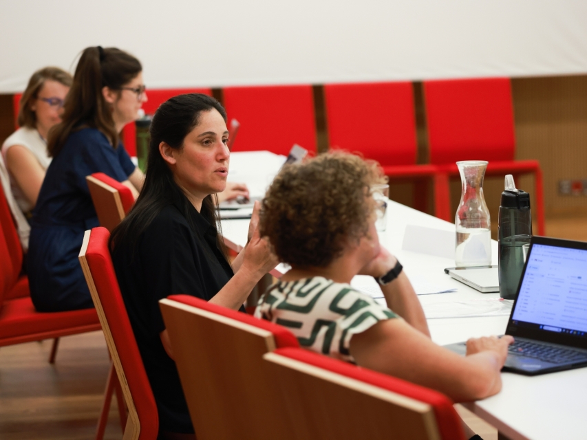 A women sitting next to each other during 2024 GEOP workhops and talking.