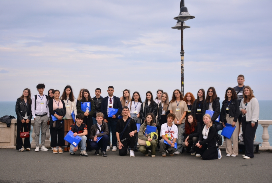 Alef competition laureates standing next to the sea.