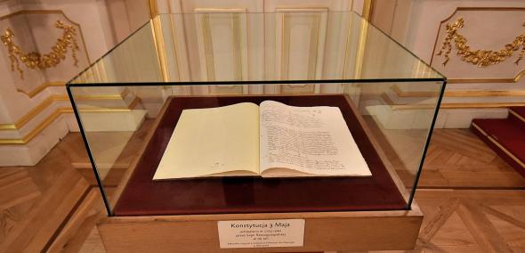Kopia Konstytucji 3 maja eksponowana w Sali Senatorskiej w Warszawie, Konstytucja w formie książki, otwarta jest na stronie tytułowej. Leży w szklanej gablocie, która stoi na wysokim postumencie. Na gablocie tabliczka z napisem Konstytucja 3 maja 