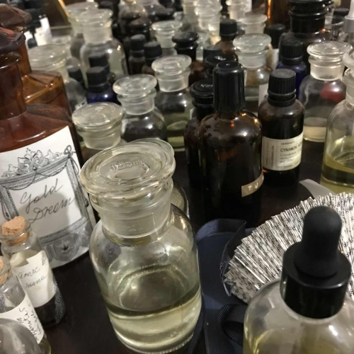 Buteleczki z perfumami na ladzie laboratorium perfumiarskiego